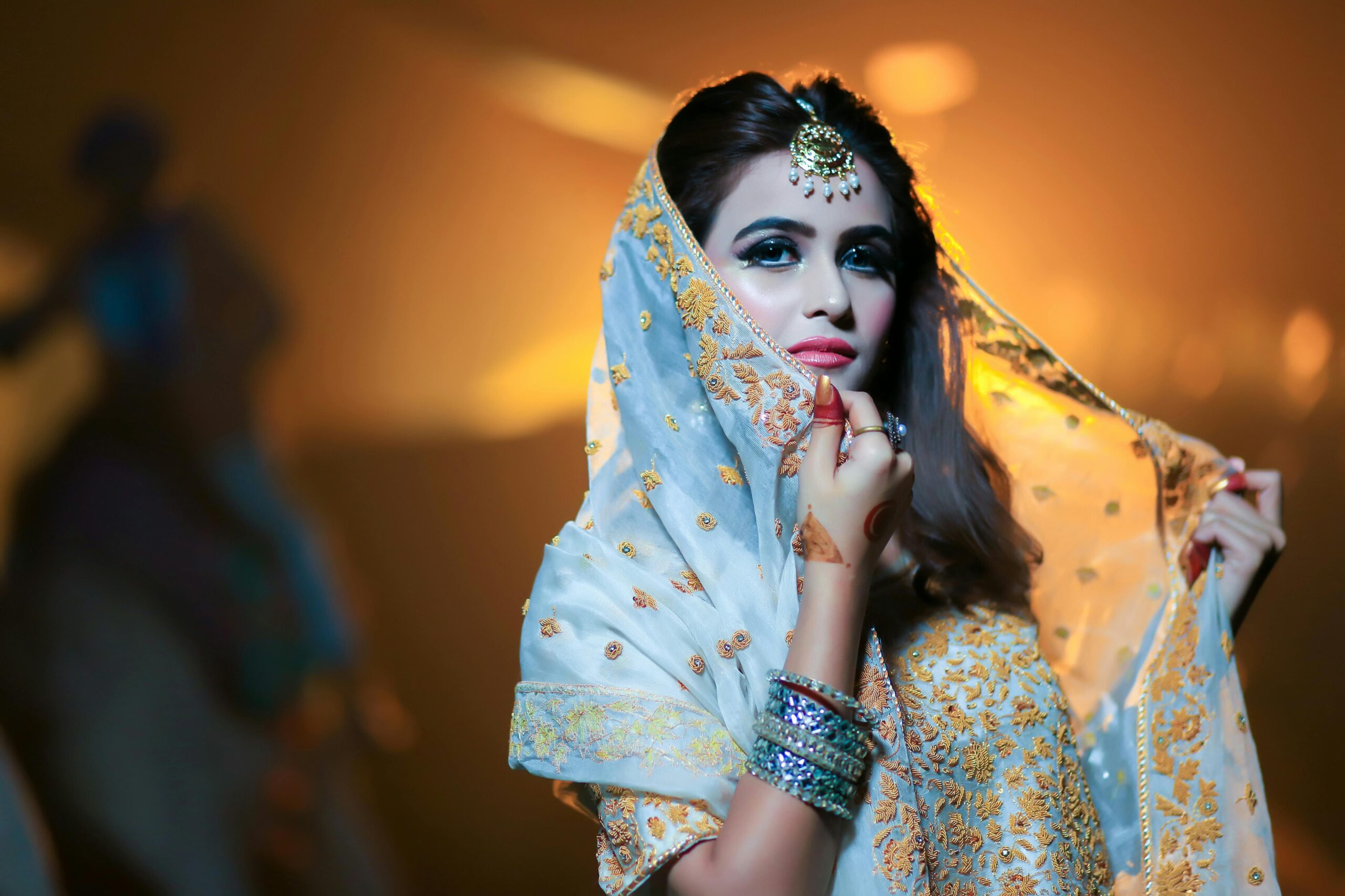 Beautiful Indian bride in traditional attire with intricate jewelry and makeup.